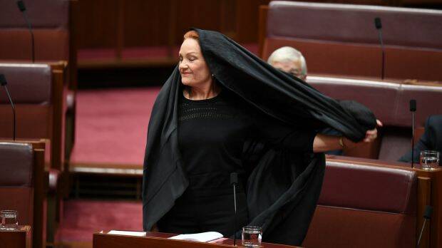 One Nation senator Pauline Hanson takes off the burqa. Photo: Lukas Coch
