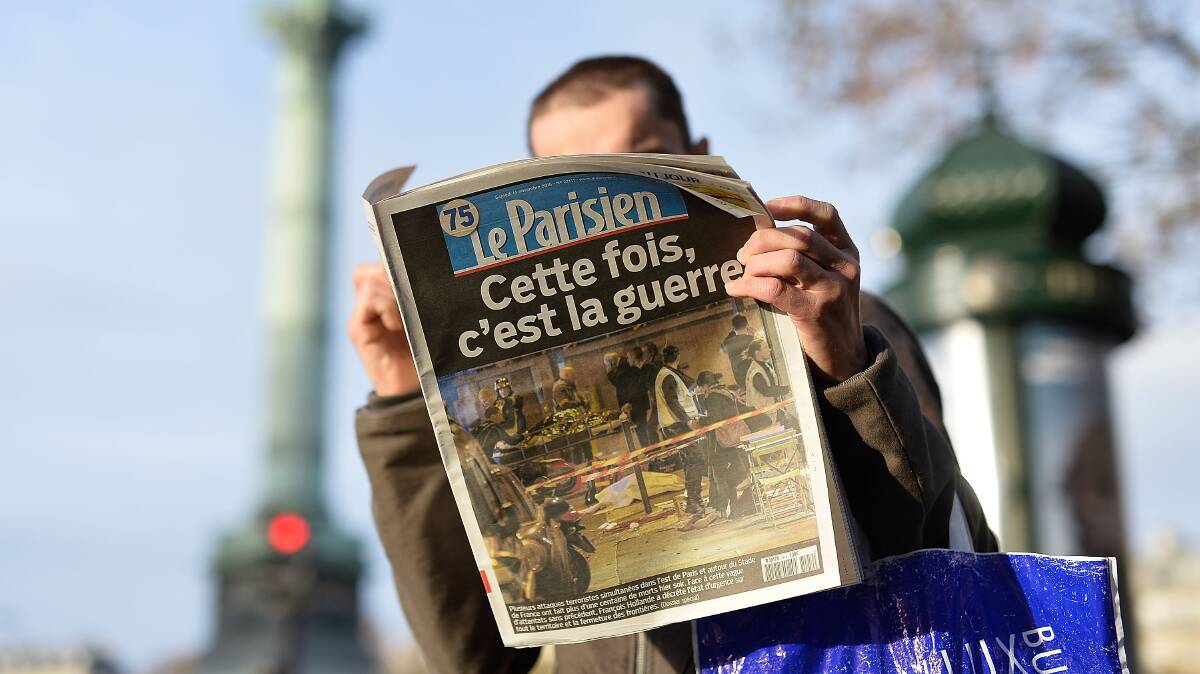 A man reads a French newspaper after a terrorist attack on November 14, 2015 in Paris, France. At least 120 people have been killed and over 200 injured, 80 of which seriously, following a series of terrorist attacks in the French capital. Pic: Pascal Le Segretain/Getty Images