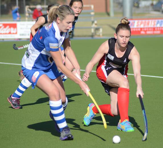 PICTURED: Parkes United’s Bec Cowling (right) attempted to regain possession with this tackle against Bathurst side St Pat’s at Stephen Davies Field last Saturday. 

Photo: Renee Powell 0715Hockey_9769