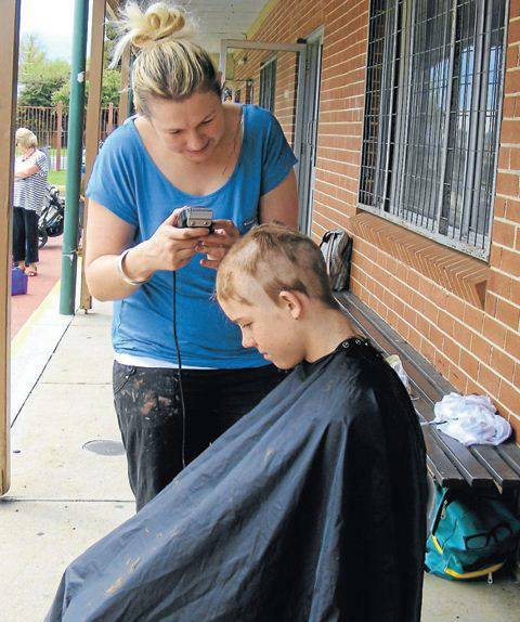 OBERON: Amanda Armstrong shaving Sam Howe’s locks as part of the World's Greatest Shave at Oberon Public School.