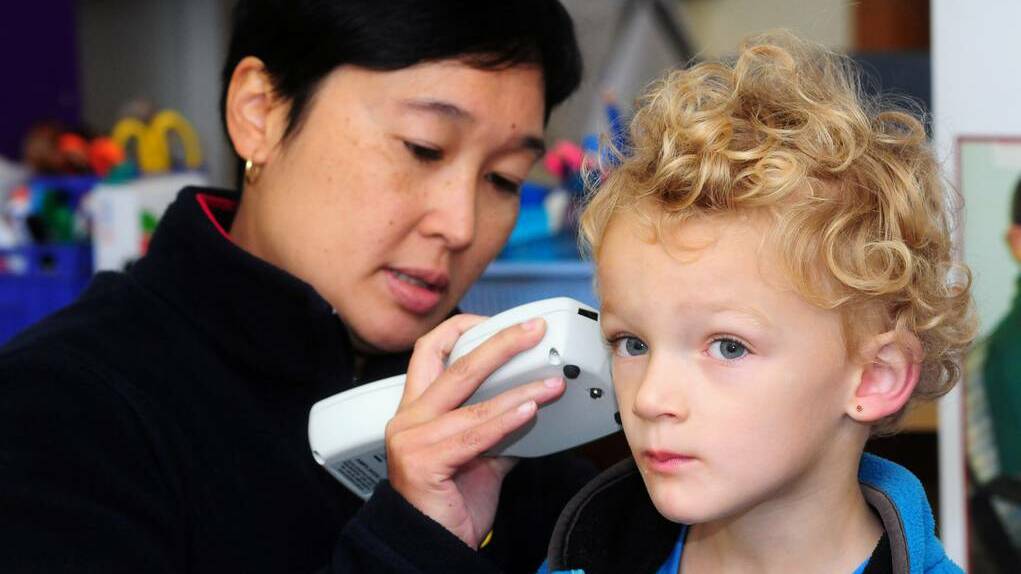 Audiologist Jocelyn Ho with Royal Institute for Deaf and Blind Children conducting a tympanometry, checking the health of the middle ear, on Nicholas Jones, a pre-school student at Dubbo West Public School. Photo: LOUISE DONGES