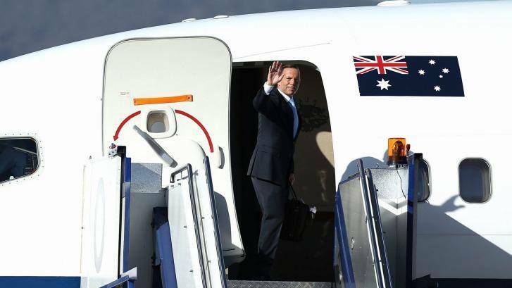 Focusing on jobs: Tony Abbott boards his flight for APEC in Beijing. Photo: Alex Ellinghausen