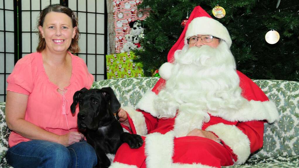 Natasha Cole getting a photo with her dog Lollipop and Santa. Photo: KATHRYN O'SULLIVAN.
