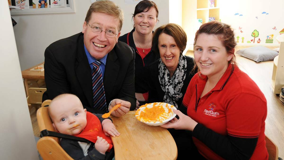Dubbo MP Troy Grant, Red Gum Child Care Centre director Deanna McCarthy, early childhood education minister Leslie Williams and Red Gum staff member Molly-May Pearce give their attention to baby Dougal Kelly. Photo: BELINDA SOOLE