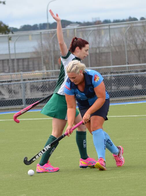 COMING THROUGH: Souths’ Nikki Braun runs the ball at Kelso rival Kirsten Howard from a quick penalty tap, meaning Howard could not be involved with play as she had not retreated five metres. Photo: ANYA WHITELAW 	090714yhockey1