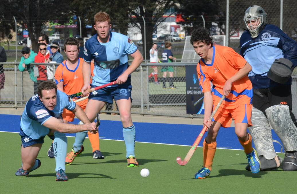 CLOSE CALL: Jack Bright clears the ball out of the circle in Saturday's men's Premier League Hockey minor semi-final  against Orange Wanderers. Photo: PHILL MURRAY 082215pwander3