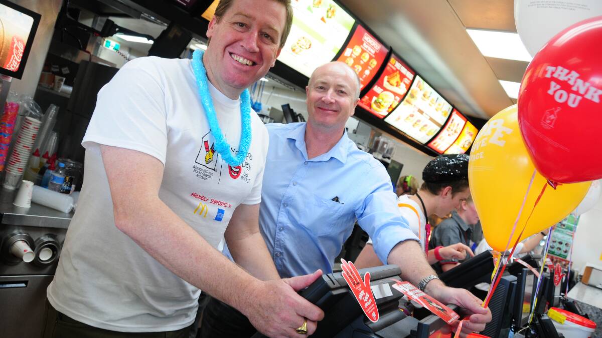 Troy Grant member for Dubbo helping out Gary Barraclough owner of the Dubbo McDonalds at McHappy Day. 
									        Photo: KATHRYN O'SULLIVAN  