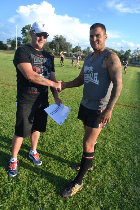 Chris Thompson (right)  with Cowboys president Trent McQuillan. Mr Thompson re-signed for the club in 2014.    