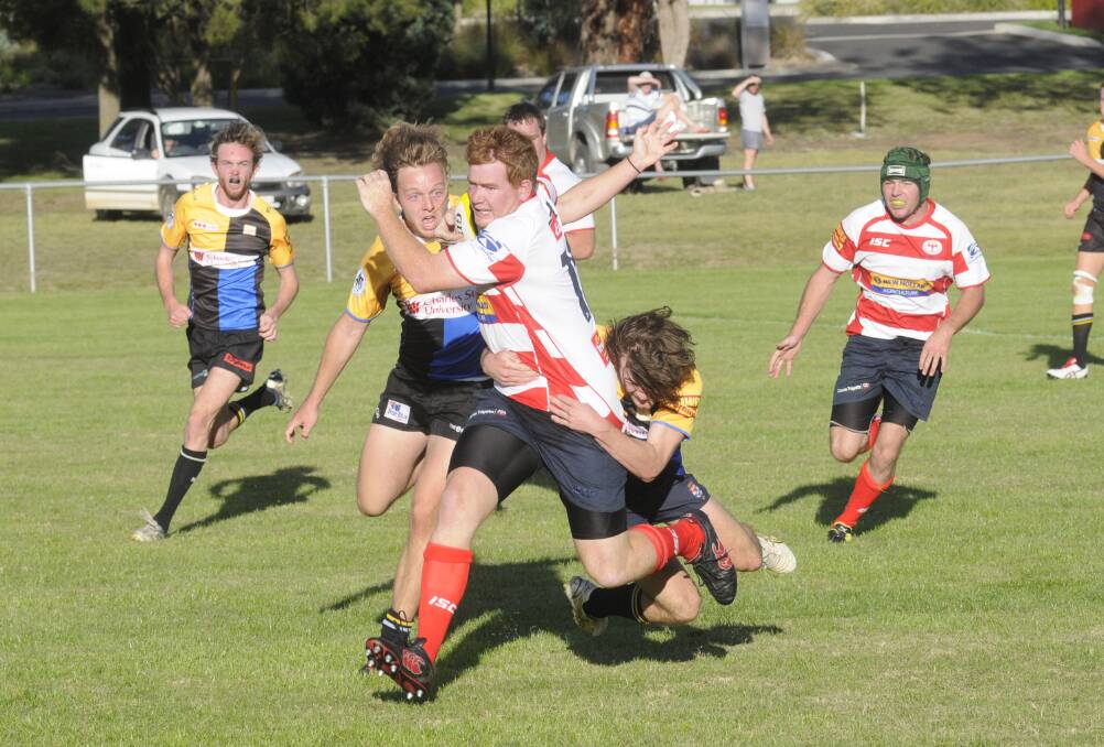 GIVING CHASE: CSU players James Tooth (left) and Maui Moodi (tackling) will be hoping their side can get a maiden win for 2015 before letting their Central West Rugby Union rivals get too far away. Photo: CHRIS SEABROOK	 041115cowra6
