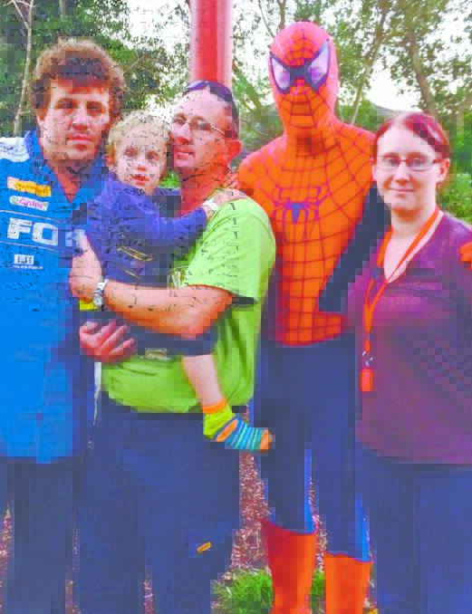 DEVASTATING NEWS: Shaun Peters, David Whitwell holding Braiden, with ‘Spiderman’ and Megan Whitwell pictured at The Children’s Hospital at Westmead on Sunday. David Whitwell said Braiden was having a terrible day until Spiderman popped in, and totally changed his demeanour.