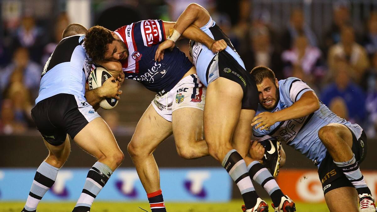 Aiden Guerra of the Roosters is tackled during the round seven NRL match between the Cronulla-Sutherland Sharks and the Sydney Roosters at Remondis Stadium on April 19, 2014 in Sydney, Australia. Photo: Mark Nolan/Getty Images.