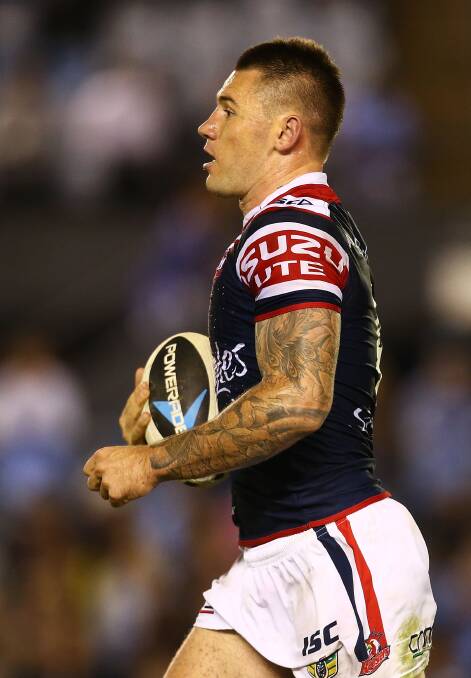 Shaun Kenny-Dowall of the Roosters runs the ball during the round seven NRL match between the Cronulla-Sutherland Sharks and the Sydney Roosters at Remondis Stadium on April 19, 2014 in Sydney, Australia. Photo: Mark Nolan/Getty Images.
