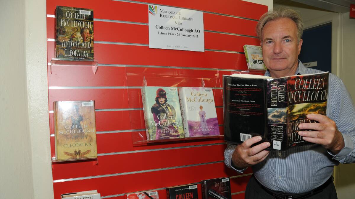 Macquarie Regional Library director, John Bayliss with the display of Colleen McCullough books to celebrate her life. Photo: HANNAH SOOLE.