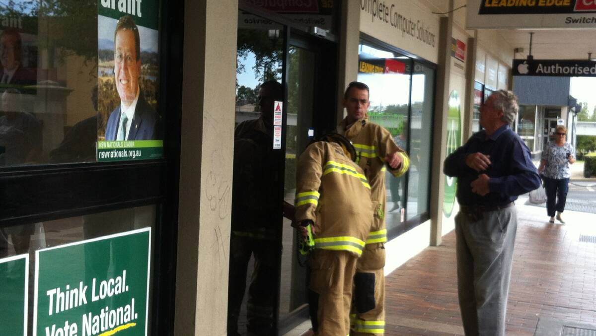 Firefighters inspect Troy Grant's campaign office in Dubbo after a fire alarm sounded on Sunday morning.