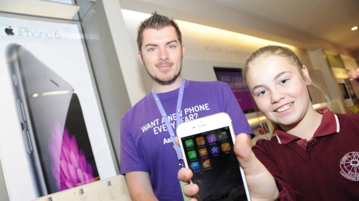 Telstra Shop store manager Dane Stevenson with Courtney Moult, the proud owner of a brand new iPhone 6. Photo: BELINDA SOOLE.