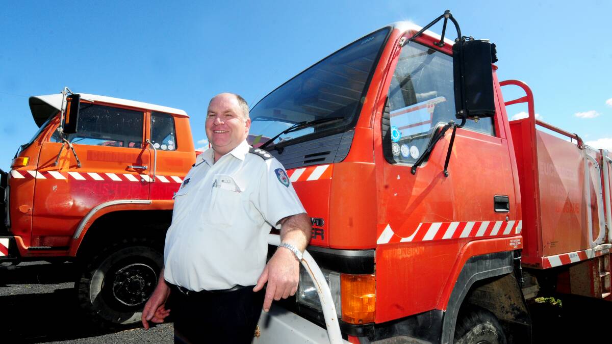 Mark Pickford from the Orana RFS with some of the trucks that are being sold via online auction as part of a long-term plan to upgrade vehicles and equipment. Photos: LOUISE DONGES.