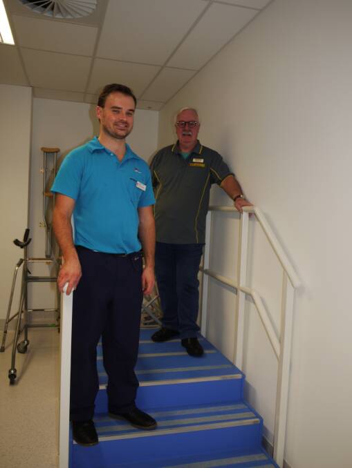 Dubbo Hospital's senior orthopaedic physiotherapist Craig Lennox and secretary of Dubbo Community Men's Shed Incorporated John Gibson inspect the new stairs. Photo: KIM BARTLEY