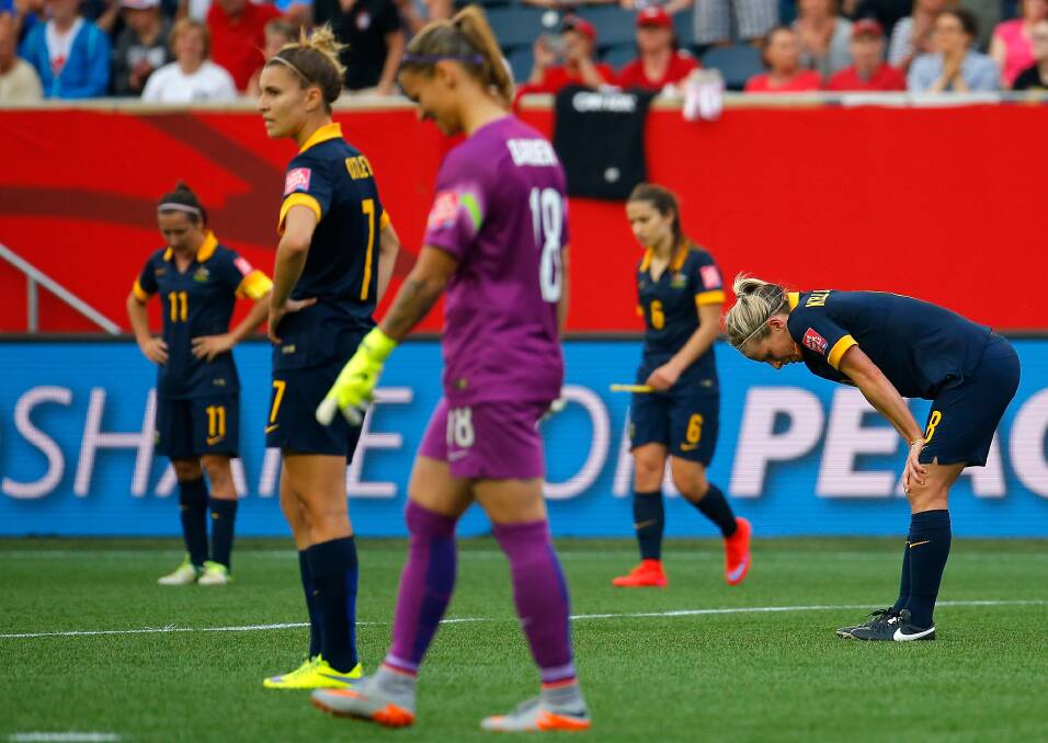 Australian players are left dejected after America scored their second goal in this morning's FIFA World Cup match. Photo: GETTY IMAGES