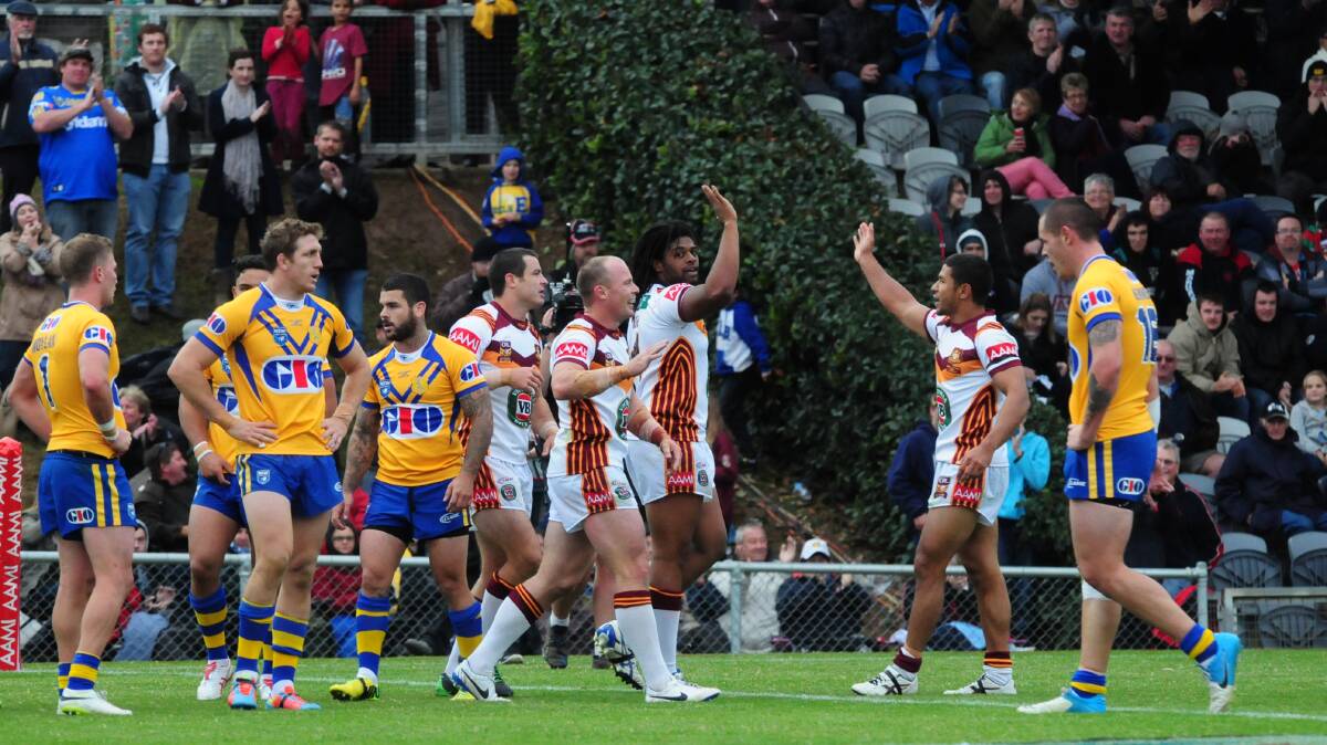 Jamal Idris celebrates a try with teammates during the City-Country match at Dubbo in 2014. Top flight NRL matches could be headed back to Dubbo from 2018. Photo: BELINDA SOOLE