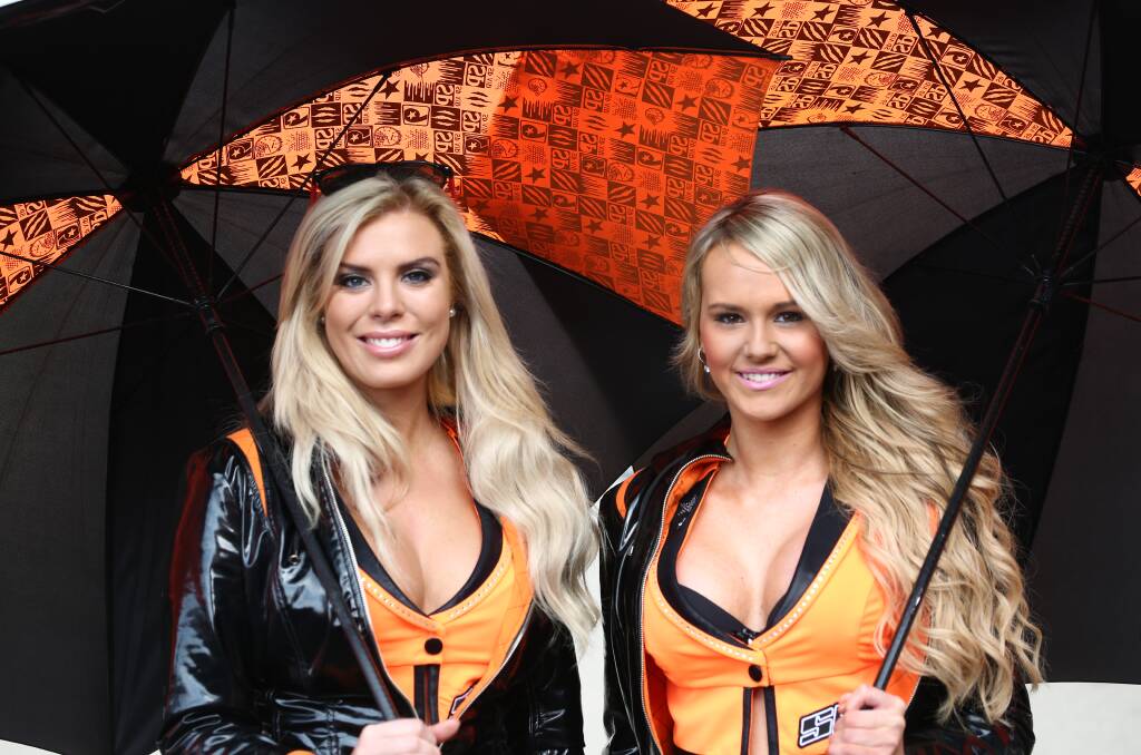 FAN FAVOURITES: Grid girls Sarah Godfrey and Carlie Shaipman were the focal point of many fan photos at the Bathurst 1000. Photo: PHIL BLATCH 101115pbgrid1