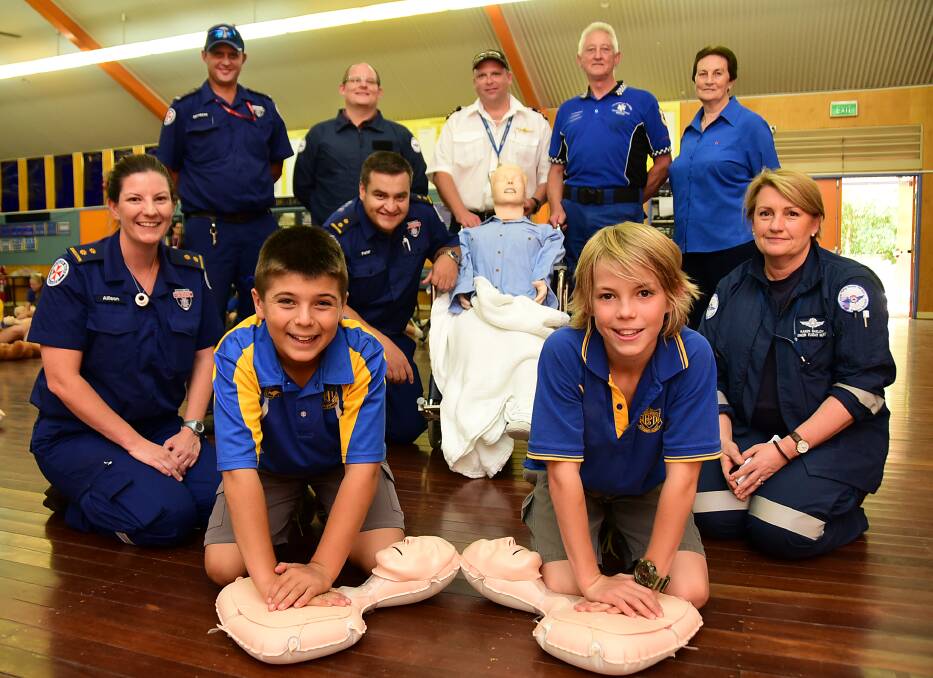 Dubbo South Public School played host to life-saving training on Monday to raise awareness of the importance of providing CPR quickly. BACK: Graham Turner (NSW Ambulance), Pete Smith  and James Brown (RFDS), Terry Joyce (Emergency Medics Australia), Leonie Richards (RFDS) MIDDLE: Allison Moffit and Peter Lang (NSW Ambulance) and Karen Barlow (RFDS). FRONT: Nat Lindsay and Connor Etcell from Dubbo South Primary School.