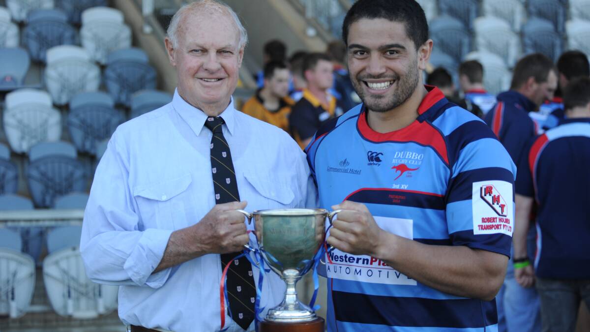 Mark Melville presents Roos captain Peter Nau with the trophy named in his honour on Saturday. Photo: BELINDA SOOLE