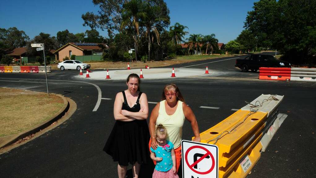 Rebecca Boehme, Annette Webber and (front) Mathilda Boehme at the roundabout that they say is poorly-designed. Photo: GREG KEEN
