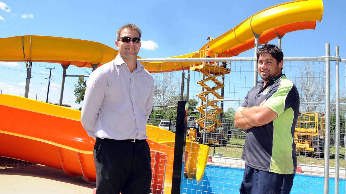Dubbo City Council sporting facilities manager Wes Giddings and Dubbo Aquatic Leisure Centre manager Nick Wilson with the replacement twin water slides on track for use this summer. Photo: BELINDA SOOLE 