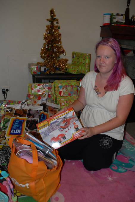 Kiara White with presents donated by the community for her children after thieves broke into her house on Sunday and stole the presents she had bought. Photo: ZENIO LAPKA 