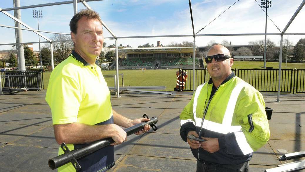 ON THEIR GAME: Butlers Events and Staging project managers Martin Webb and Corey Wall work on the scaffold deck and marquee being installed at Carrington Park ahead of the Penrith Panthers and Cronulla Sharks match. Photo: CHRIS SEABROOK