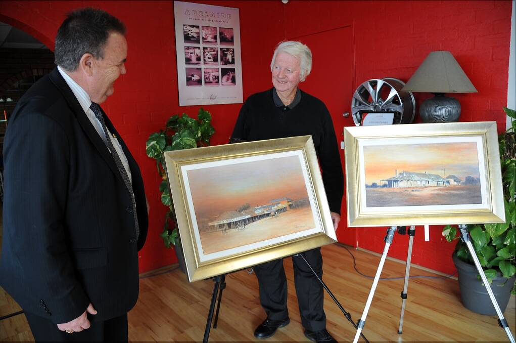 Terry Green of Sainsbury Automotive and Rex Newell with his artworks that will be auctioned. Photo: BELINDA SOOLE.