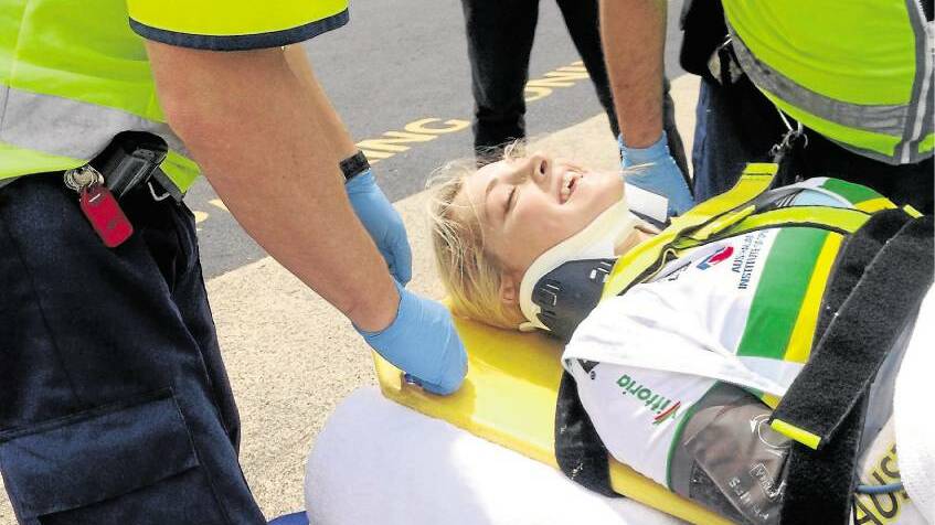 Ambulance personnel take injured cyclist Macey Stewart into hospital on October 30. X-rays revealed no broken bones.