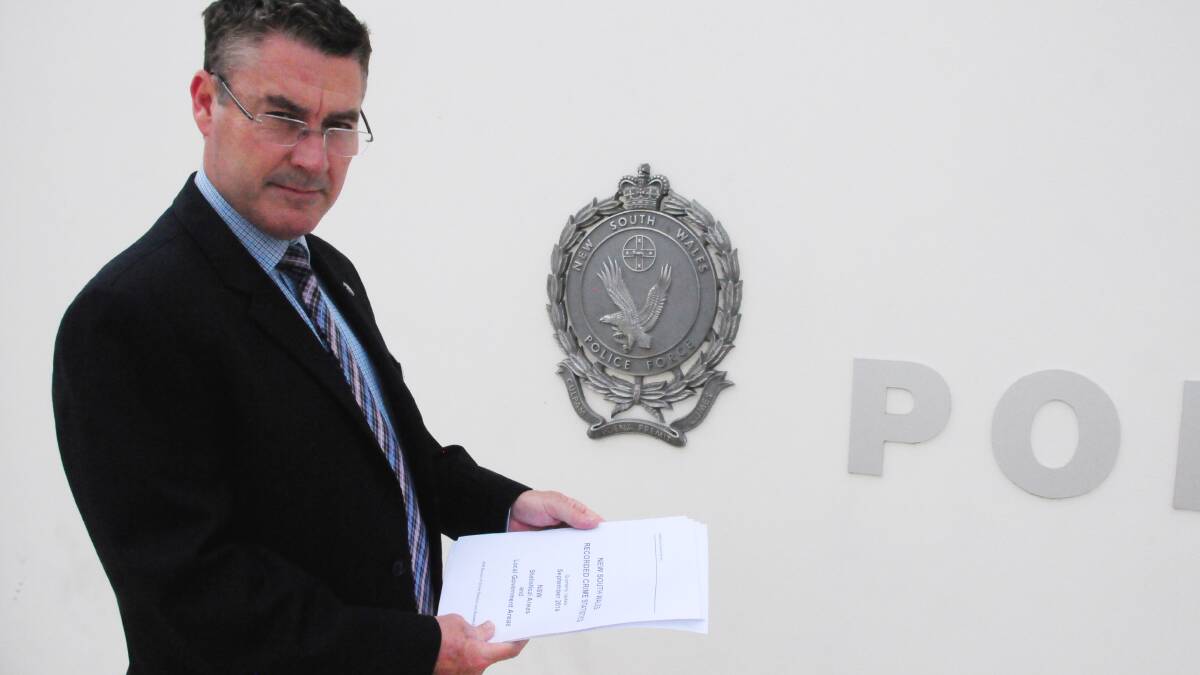 Detective Sergeant Mark Meredith inspects the latest crime figures for the Orana region. Photo: GREG KEEN.