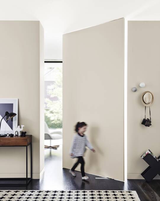 Dulux Whisper White on the ceiling, White Duck adds continuity  to the swivel door and walls. Photo: Dulux.
