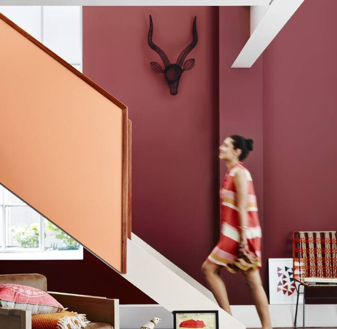 A dash of red: Marrakesh Red on the wall, Mexican Standoff on the balustrade and natural white on the stairs. Photo: Dulux.