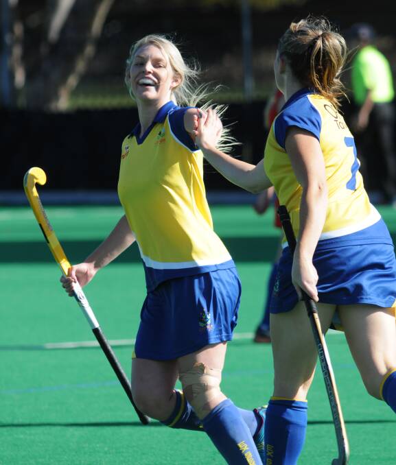 WINNERS: Kate Butcherine and Leanne Kennewell celebrate a goal and they'll be hoping for a few more in Parkes today. Photo: JUDE KEOGH 0516hockey10