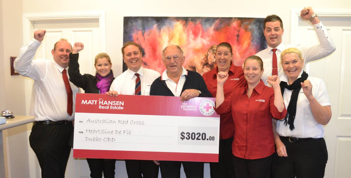CHEERING: The team from Matt Hansen Real Estate presenting the cheque to Red Cross Dubbo's George Chapman. Photo: ORLANDER RUMING