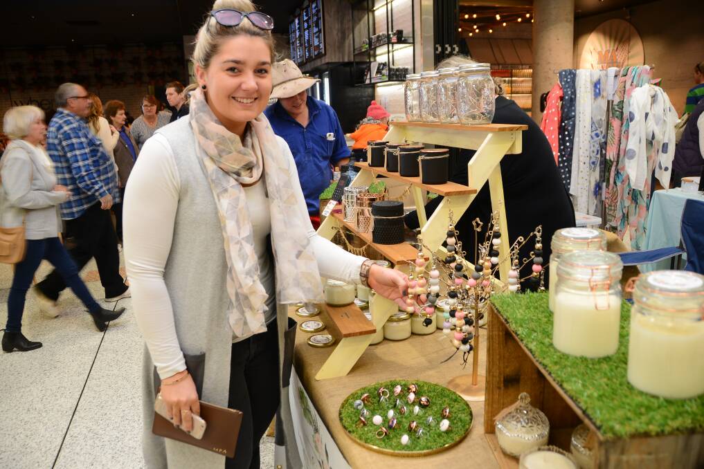 CHECKING THE WARES: Mollie Anning was among the huge crowd of people who went to Orana Mall to look at the inaugural indoor markets held recently. Photo: PAIGE WILLIAMS