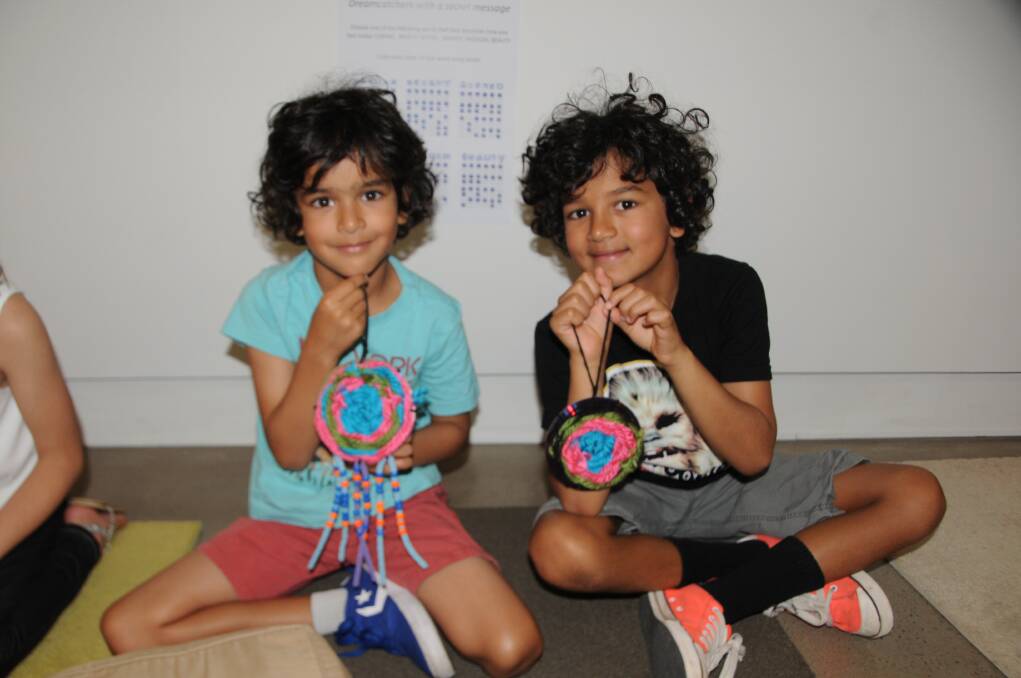 ART AND COMPUTERS: Zeon Berger and Zamael Berger with their dream catchers made at the Western Plains Cultural Centre's school holiday workshop. Photo: ORLANDER RUMING