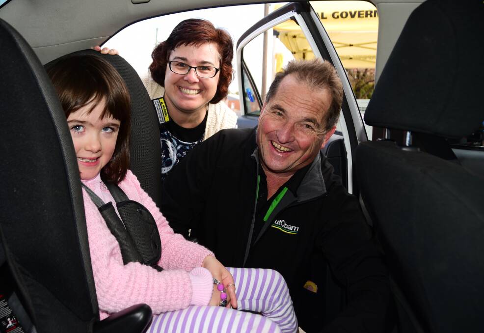 SEAT CHECK: Angela McColl and Monica McColl had the car seat checked with the help of Autobarn's Neil Sturrock at a previous Seatbelt Saturdays. Photo: BELINDA SOOLE