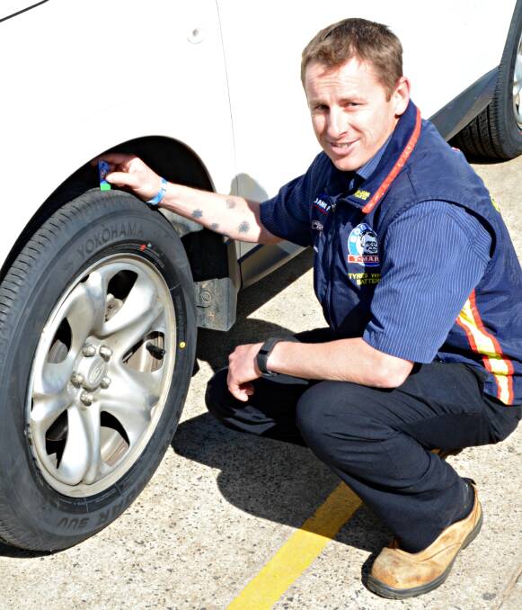 GREEN LIGHT: Scott Lacrosse from Bob Jane T-Marts Dubbo testing the tyre pressure on the car as part of the free checks available during Tread Safety Week. Photo: ORLANDER RUMING