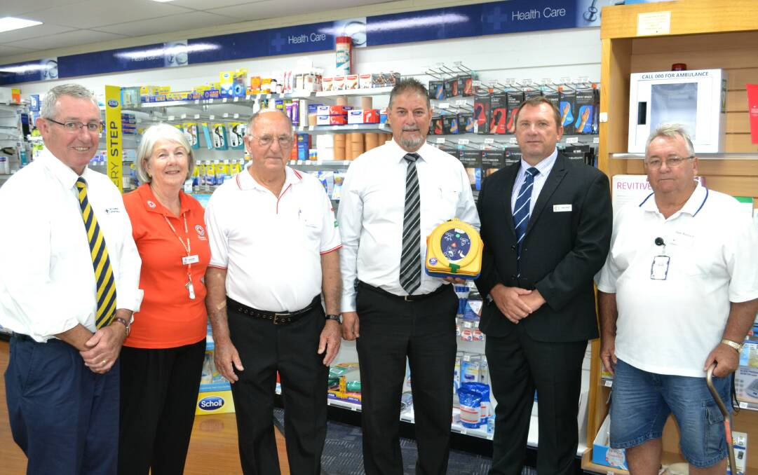 HEART: Tim Koerstz, Yvonne Dodd, George Chapman, Gus Lico, Greg Mohr and Allan Warwick with the defibrillator which was installed at the pharmacy. Photo: ORLANDER RUMING