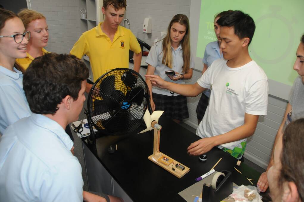 RENEWABLE ENERGY: Students had to get their handmade fans to move in the "wind" to see how many of the lights would work. Photo: ORLANDER RUMING