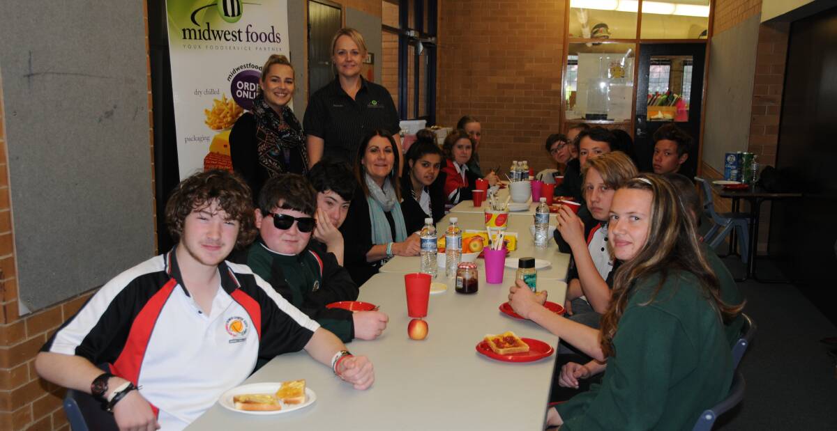 TOAST AND CEREAL: Dubbo College Delroy Campus teacher Holly Cronk, Midwest Foods retail manager Belinda Roberts and principal Debbie Head having breakfast with the support students. Photo: ORLANDER RUMING