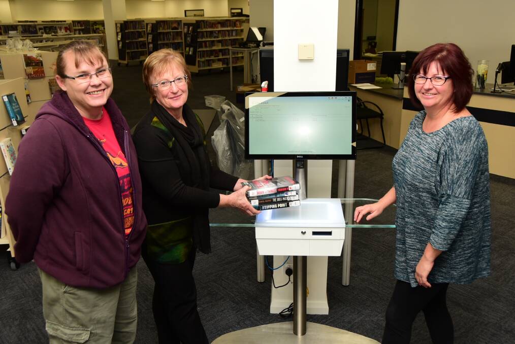 CHECK IT OUT: Macquarie Regional Library staff Janelle Shipp, Lindy Allan and Fiona Dunn with the self checkout which has been installed at the library. Photo: Belinda Soole