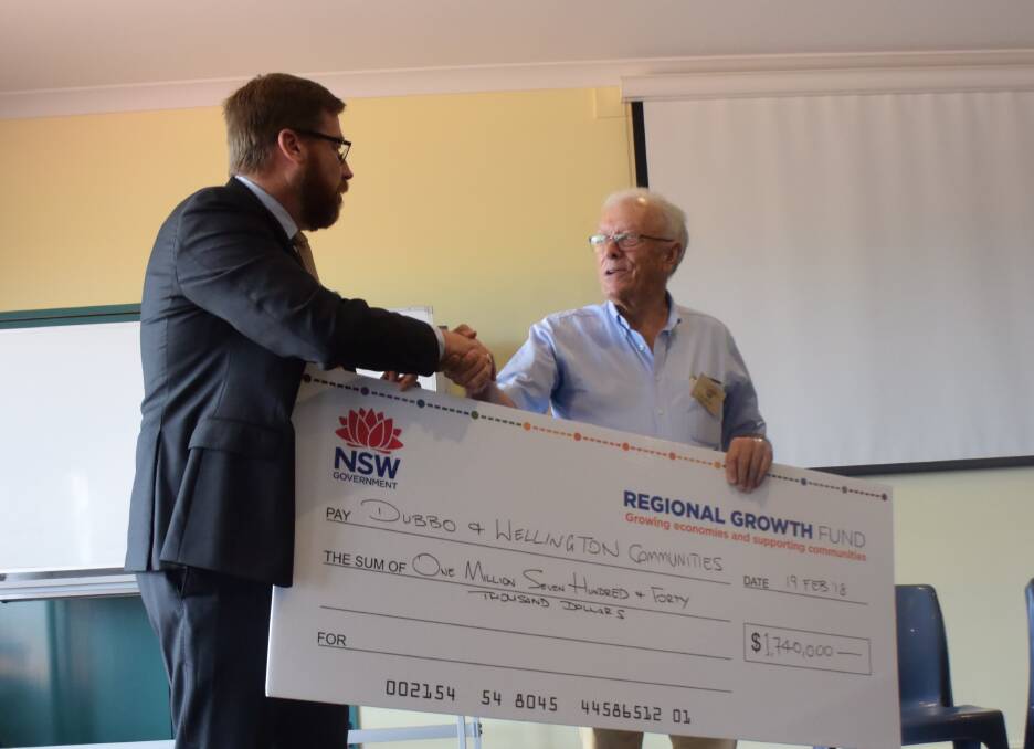 WELCOME FUNDING: Member for Dubbo Troy Grant presenting the $1.7 million Stronger Communities cheque to Narromine's Peter Kierath, who also received funding. Photo: JENNIFER HOAR