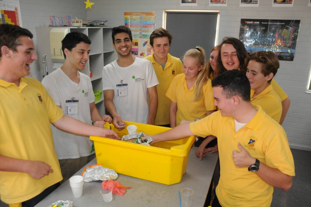 PUTTING IT TO THE TEST: St John's College students testing their boats to see which could hold the highest number of marbles. Photo ORLANDER RUMING