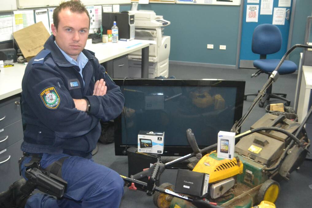 Constable Tom Cambourn with a number of goods recovered from the operation. 	Photo: WELLINGTON TIMES
