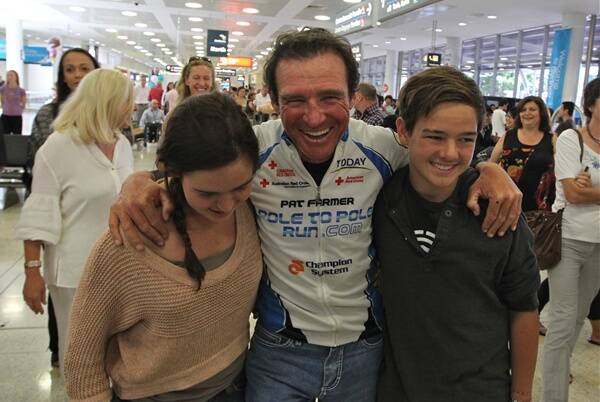 Endurance runner Pat Farmer, with his kids Brooke and Dillon, arrives back in Sydney after completing his Pole to Pole run to raise money for the Red Cross. 					              								                Photo: Ben Rushton SMH