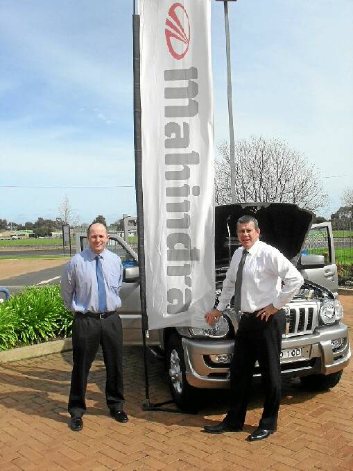 New dealer principal Chris Gibson with Greg Brimble and one of the Mahindra vehicles in stock at Clancy Ford.